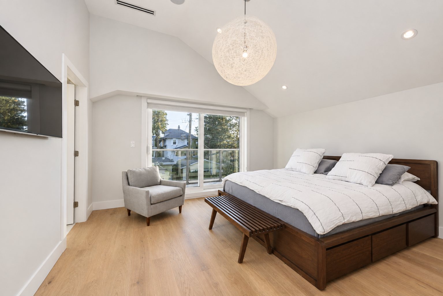 Primary bedroom with vaulted ceiling