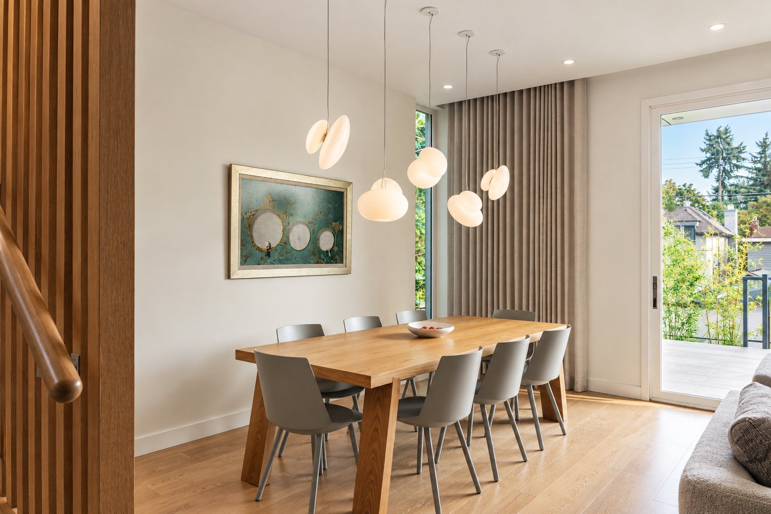 Dining room with sculptural pendant cluster and terrace access