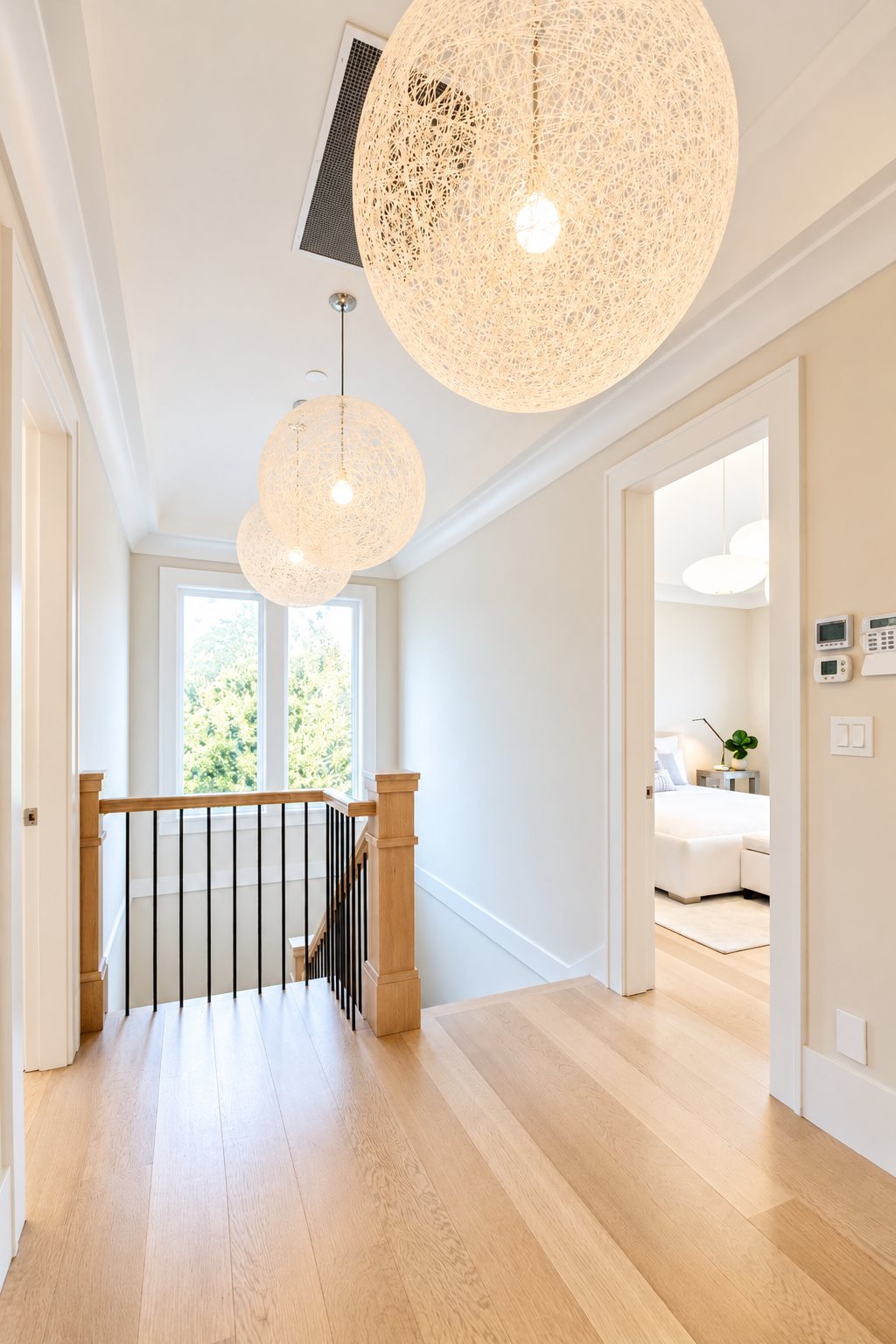 Upper hallway and staircase with Moooi pendant lighting and white oak floors
